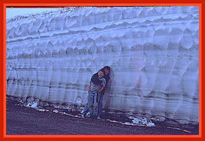 Bekah and Joe in front of a snow bank on Mount Washburn