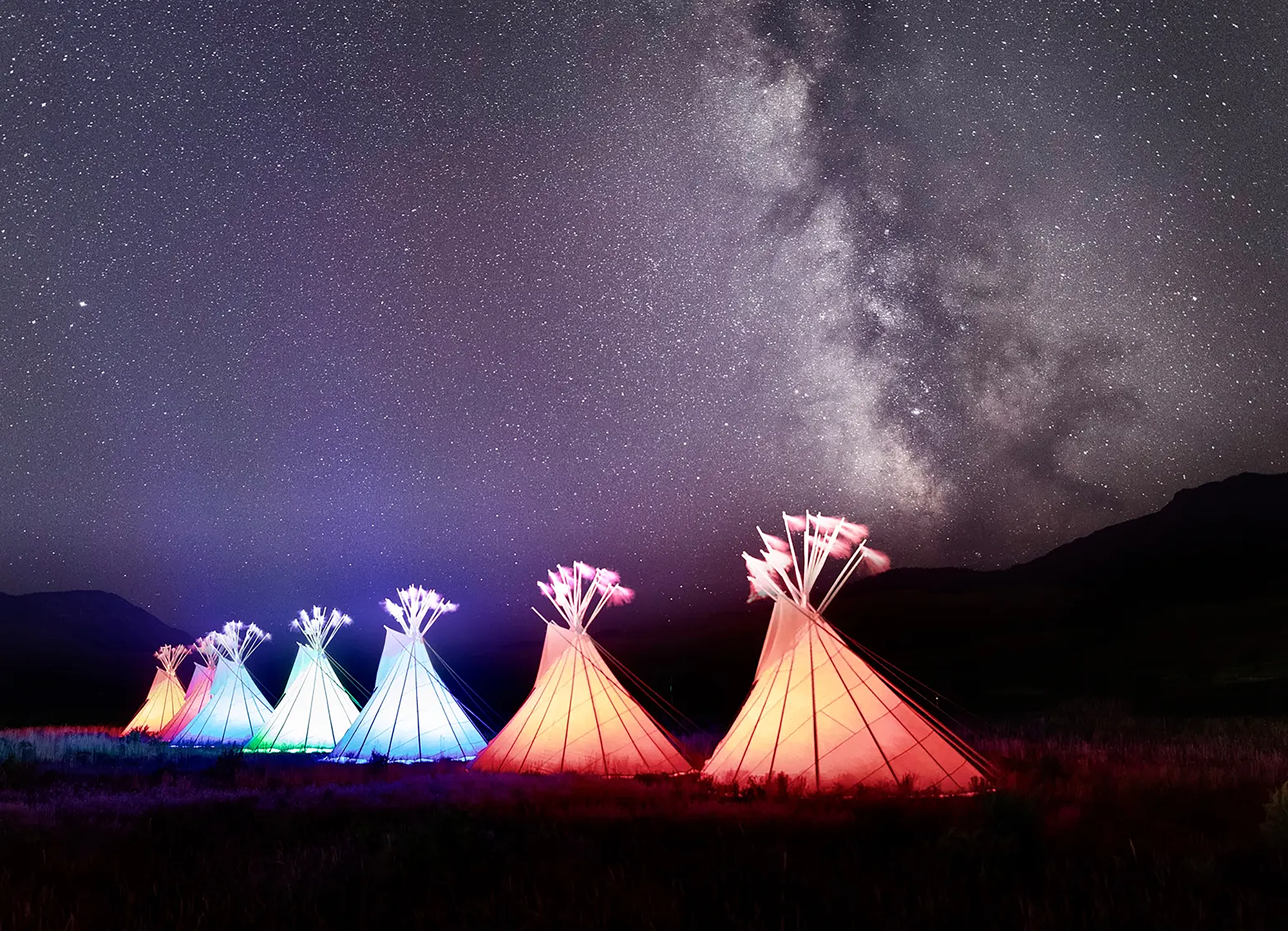Tipis at night in Yellowstone - NPS Photo